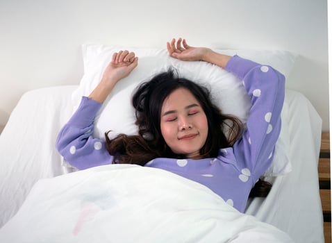 Beautiful Asian woman sleeping on a white couch. photo