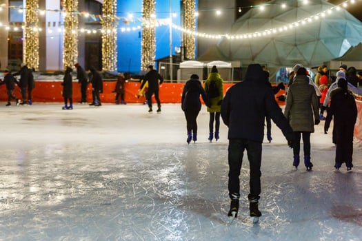 People friendship sport and leisure concept happy friends on skating rink photo