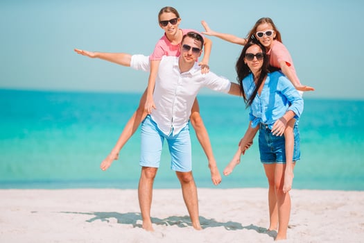 Photo of happy family having fun on the beach. Summer Lifestyle