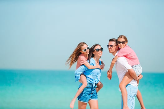 Happy family on the beach during summer vacation photo