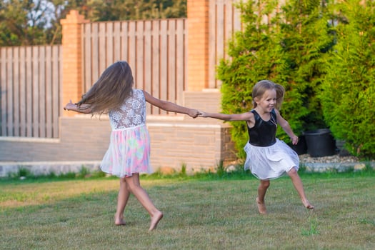 Adorable little girls having fun in park photo