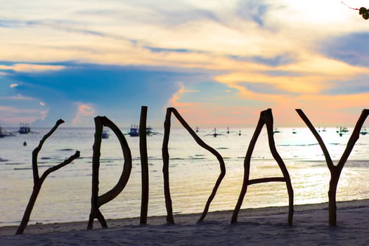 Perfect white sandy beach on tropical island with wooden letters silhouette made Friday word photo