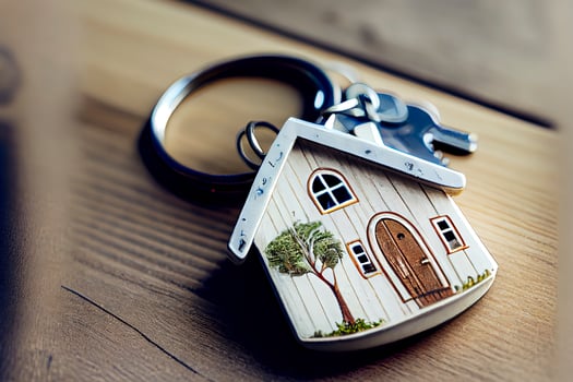 Real estate concept - Key ring and keys on white wooden background photo