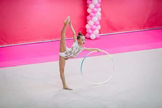 Little gymnast training on the carpet and ready for competitions photo