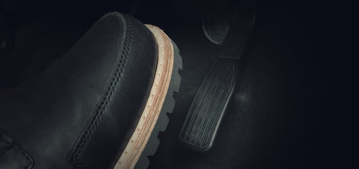 Close up foot press or push foot break and accelerate pedal of a car to drive ahead. photo