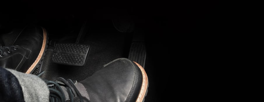 Close up foot press or push foot break and accelerate pedal of a car to drive ahead. photo