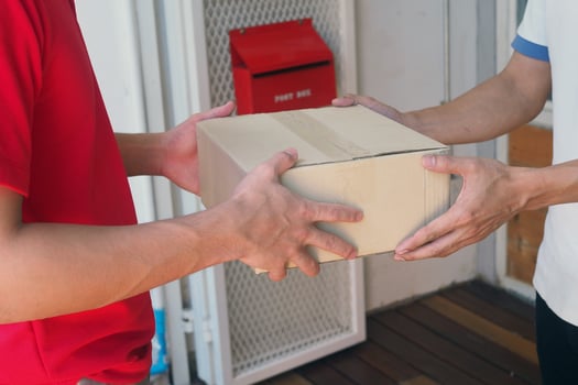 The courier sends the packaging box to the online buyer. Fast delivery service photo