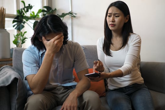The husband expressed annoyance to his wife who was checking the phone. photo