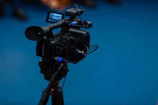 TV camera in a concert hall with laser lighting. Professional digital video camera. photo