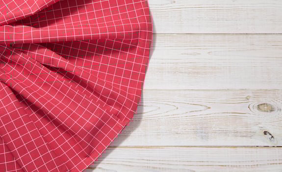 red table cloth on white wooden table photo