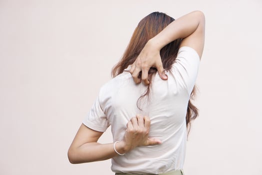 Backside of white woman back pain and ache concept,Itchy Asian woman in the back photo