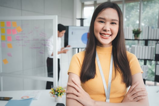 Young Asian Happy Businesswoman or intern in Modern Office background is Colleagues discuss with new startup project Idea. Empowered Digital Entrepreneur Works on Startup Project photo