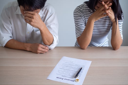 Couple is feeling stressed after agreeing to sign a divorce certificate. Concepts of lovers having family problems, divorce or quarrels or conflicts photo
