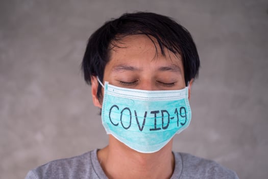 Asian man Worry and Fears Wearing Mask, writes Covid-19 The situation of the 2019-nCoV virus infection in Wuhan is spreading all over the world. Deadly plague of the world Masked concept to protect photo