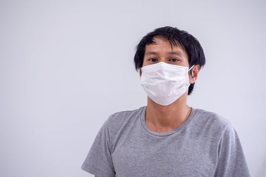 Face image of Asian men wearing masks to protect against Corona Virus or Covid 19 and toxic fumes and dust. PM 2.5 photo