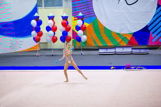 Beautiful little active gymnast girl with her performance on the carpet photo