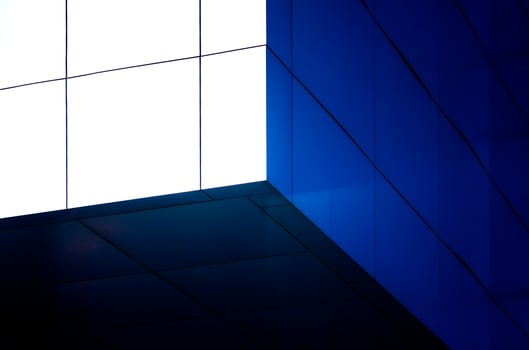fragment of the wall of a modern blue building on a white background photo