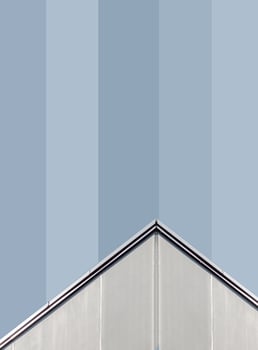 corner of a gray concrete building with windows photo
