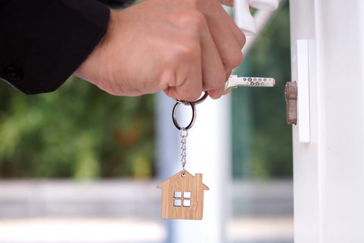 Landlord unlocks the house key for new home photo