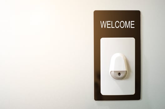 Close up of Welcome door ring on the wall background. doorbell button and welcome text sign at the entrance home. business concept for creative design photo