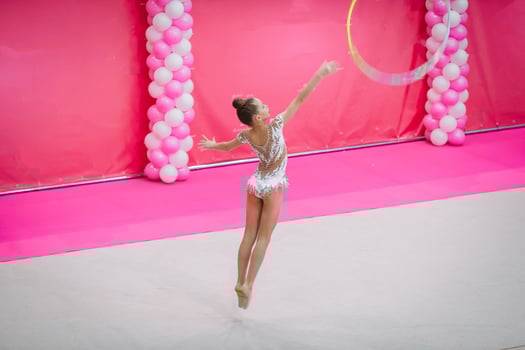 Little gymnast training on the carpet and ready for competitions photo
