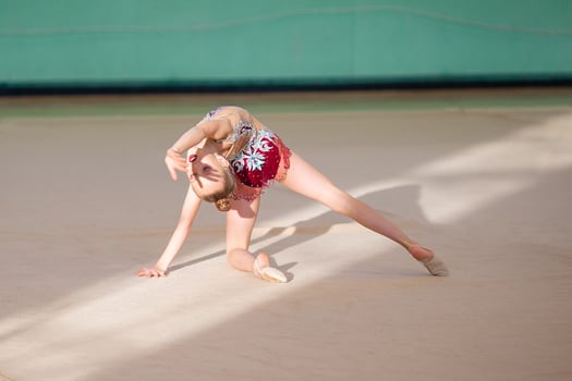 Little gymnast training on the carpet and ready for competitions photo