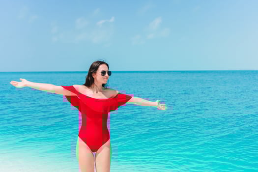 Young woman on a tropical beach with hat photo