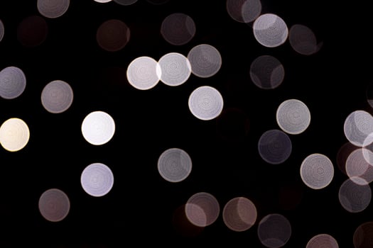 Abstract bokeh of white lights on black background. defocused and blurred many round light photo