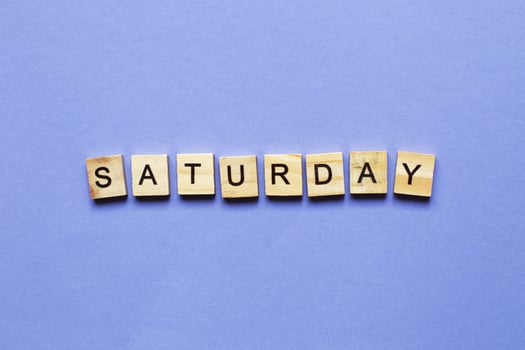 inscription Saturday made by wooden cubes on a veri peri purple background. photo