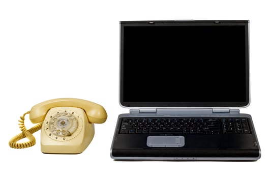 Laptop and old phone. Isolated on white photo
