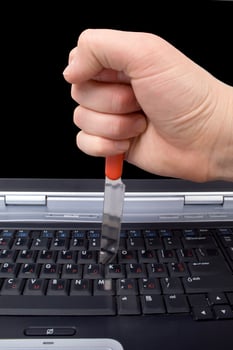Hand with a knife in the laptop keyboard photo