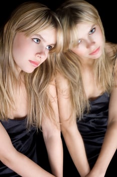 Portrait of the young blonde near a mirror photo