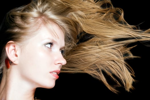 Portrait of the young beauty blonde. Isolated on black background photo
