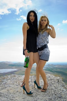 Two young women with a champagne bottle photo
