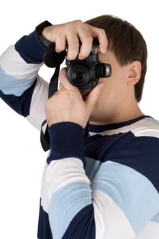 Young man with a digital camera. Isolated on white photo
