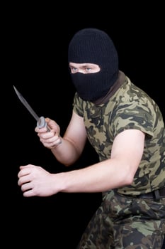 The man with a knife in a black mask photo