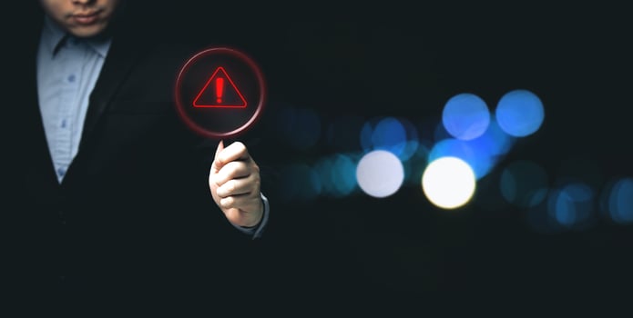 Businessman showing warning triangle warning sign showing system error Concepts of systems, security, anti-virus, and anti-hacking access to critical data. photo