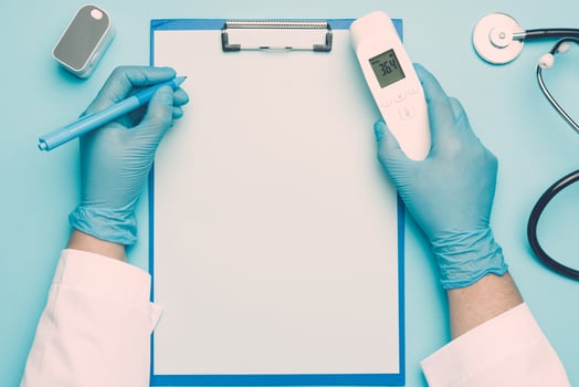 doctor's hands in blue medical gloves holds an electronic pulse oximeter photo