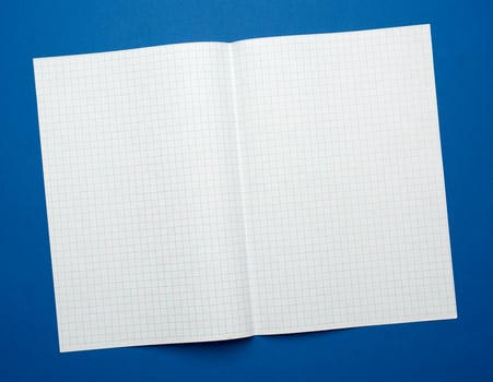 white sheet of paper in a cage from a school notebook on a blue background photo