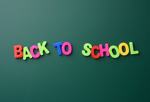 inscription back to school from multicolored plastic letters photo