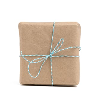 square box wrapped in brown kraft paper and tied with rope, photo