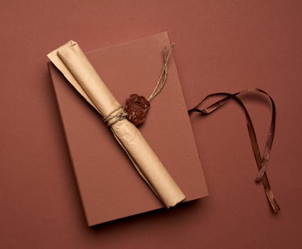 brown paper roll sealed with wax seal, top view photo
