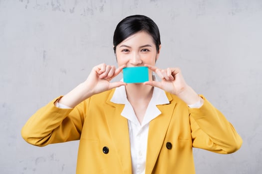 Image of young Asian woman holding bank card photo