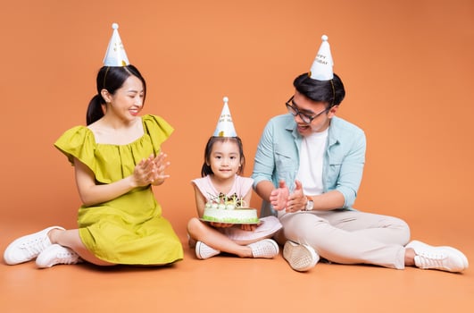 Young Asian family posing on background photo