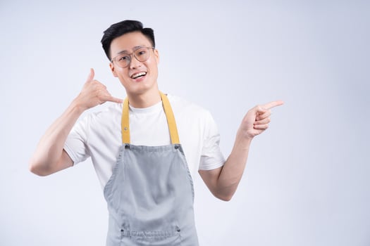 Image of young Asian waiter on background photo