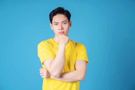 Image of young Asian man with yellow t-shirt on background photo