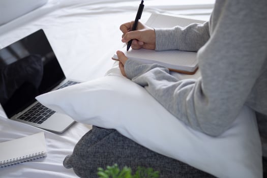 Businesswoman wearing pajamas working at home in the bedroom due to the spread of the virus Covid-19. Stay home, stop the spread of the virus. stay safe, working from home and Social distance. photo