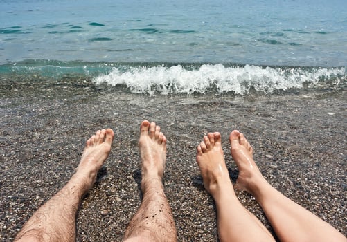 Pair legs on sea beach photo