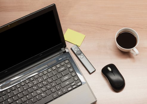 Top view laptop and coffee and accessories on table photo