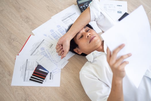 Asian men are stressed about financial problems and home expenses. With many invoices and credit card debt placed on the floor.  Financial deficit problems photo